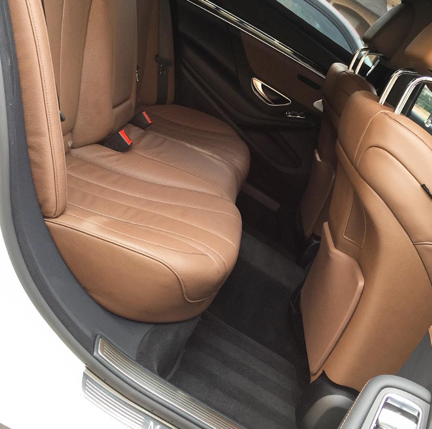 Luxury vehicle tan leather rear interior detail